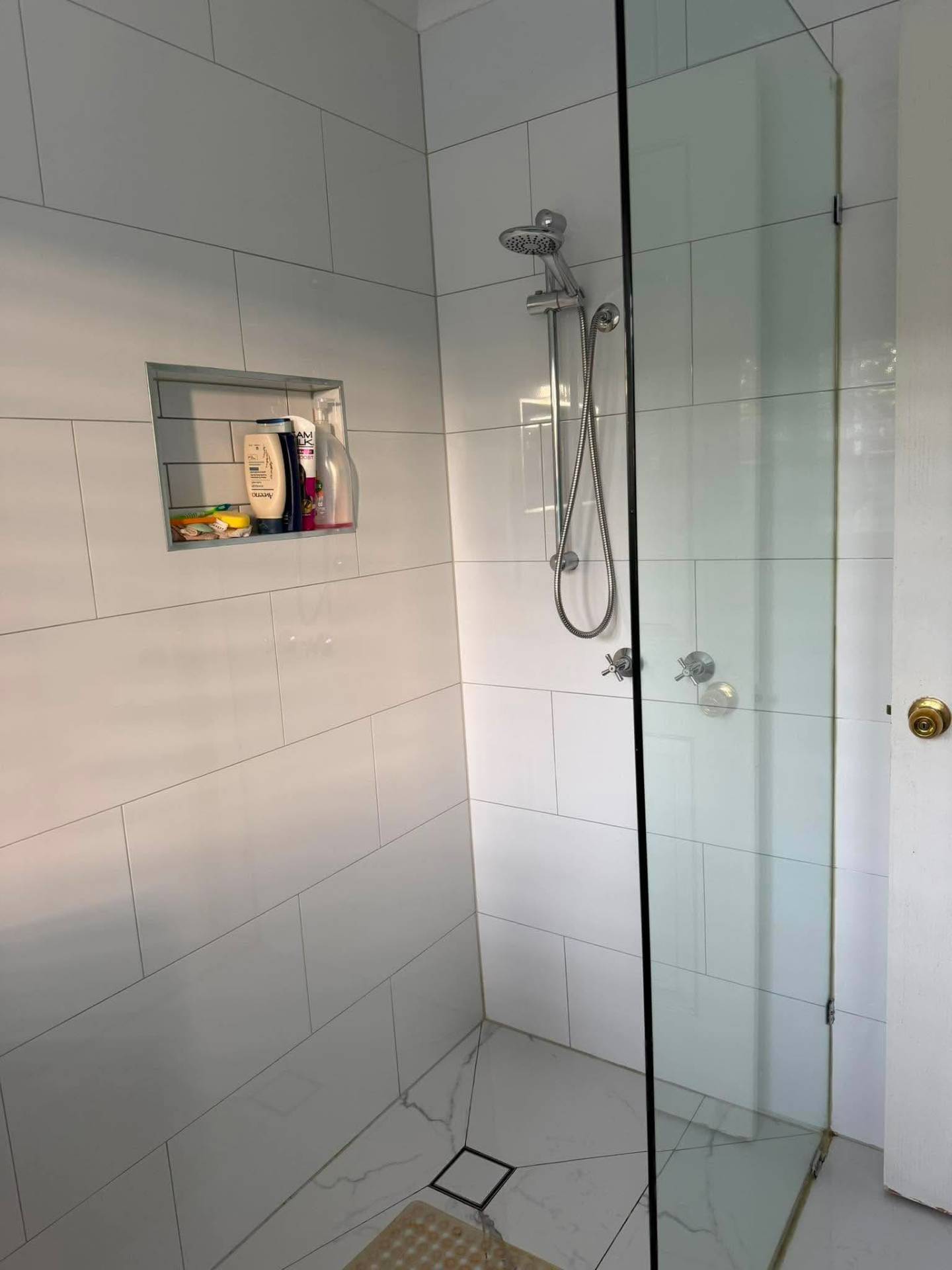Gleaming glass shower and tiled walls after a deep clean by No.1 Cleaning